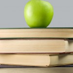 Books and green apple